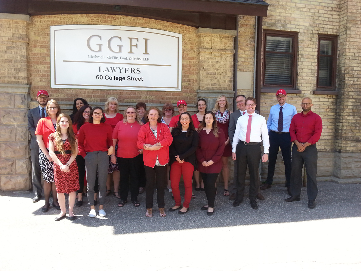 The GGFI team dressed in red standing in the sun.